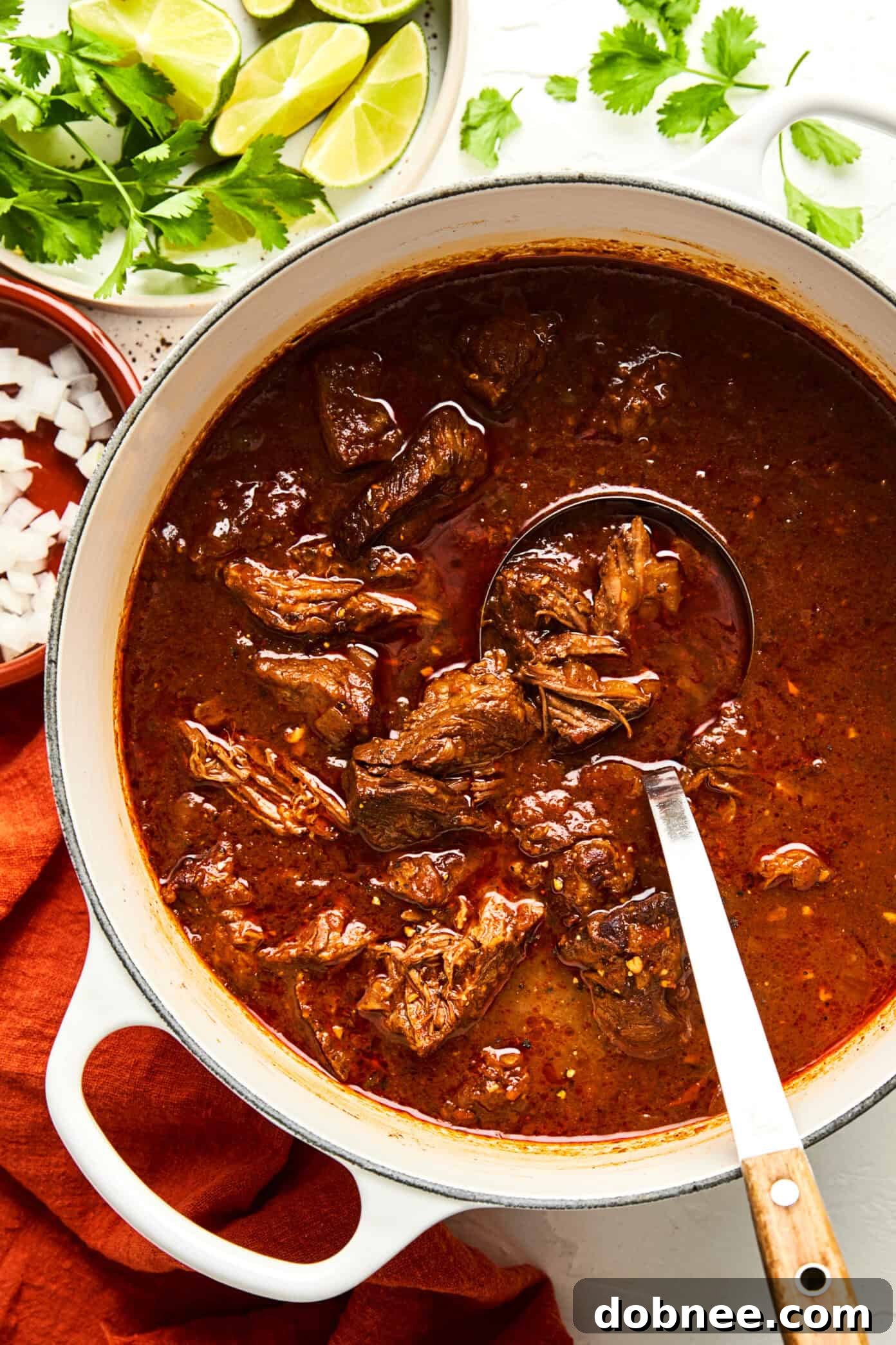 A serving of Texas Chili in a bowl, with a spoon ready to dive in.