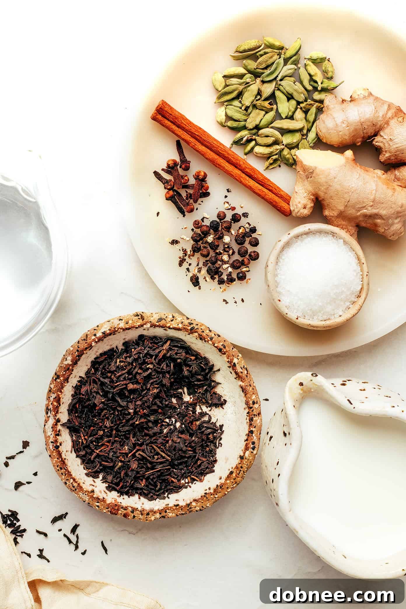 Assortment of fresh spices for Masala Chai on a wooden board
