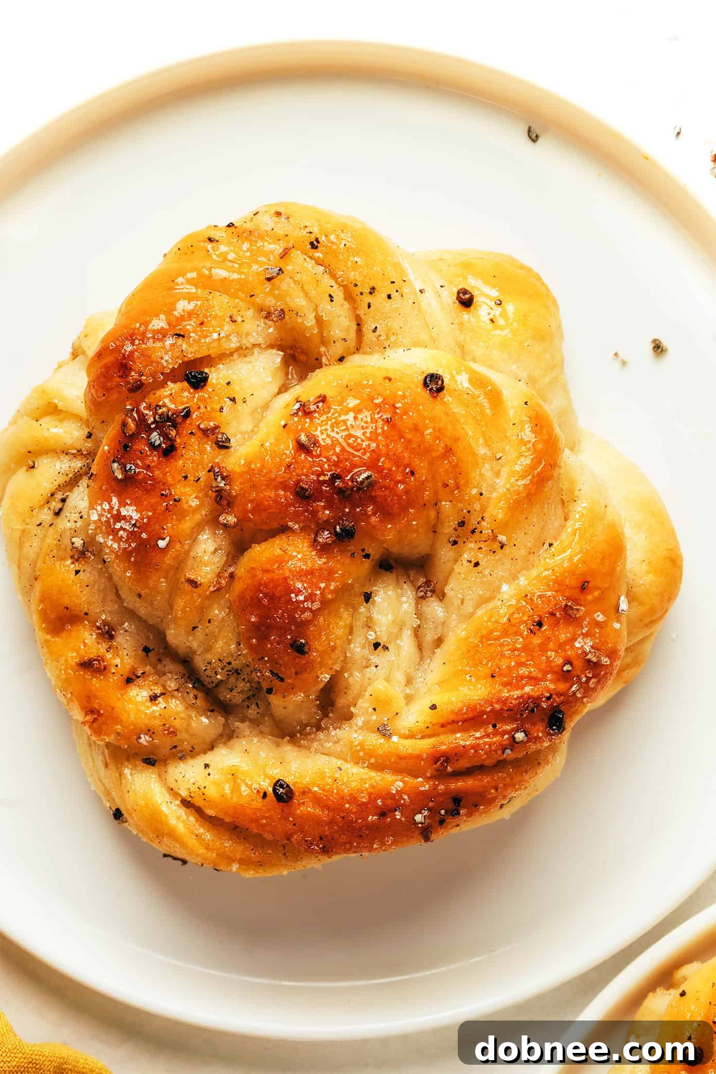 A final overhead shot of a batch of golden-brown cardamom buns, fresh from the oven, awaiting enjoyment.
