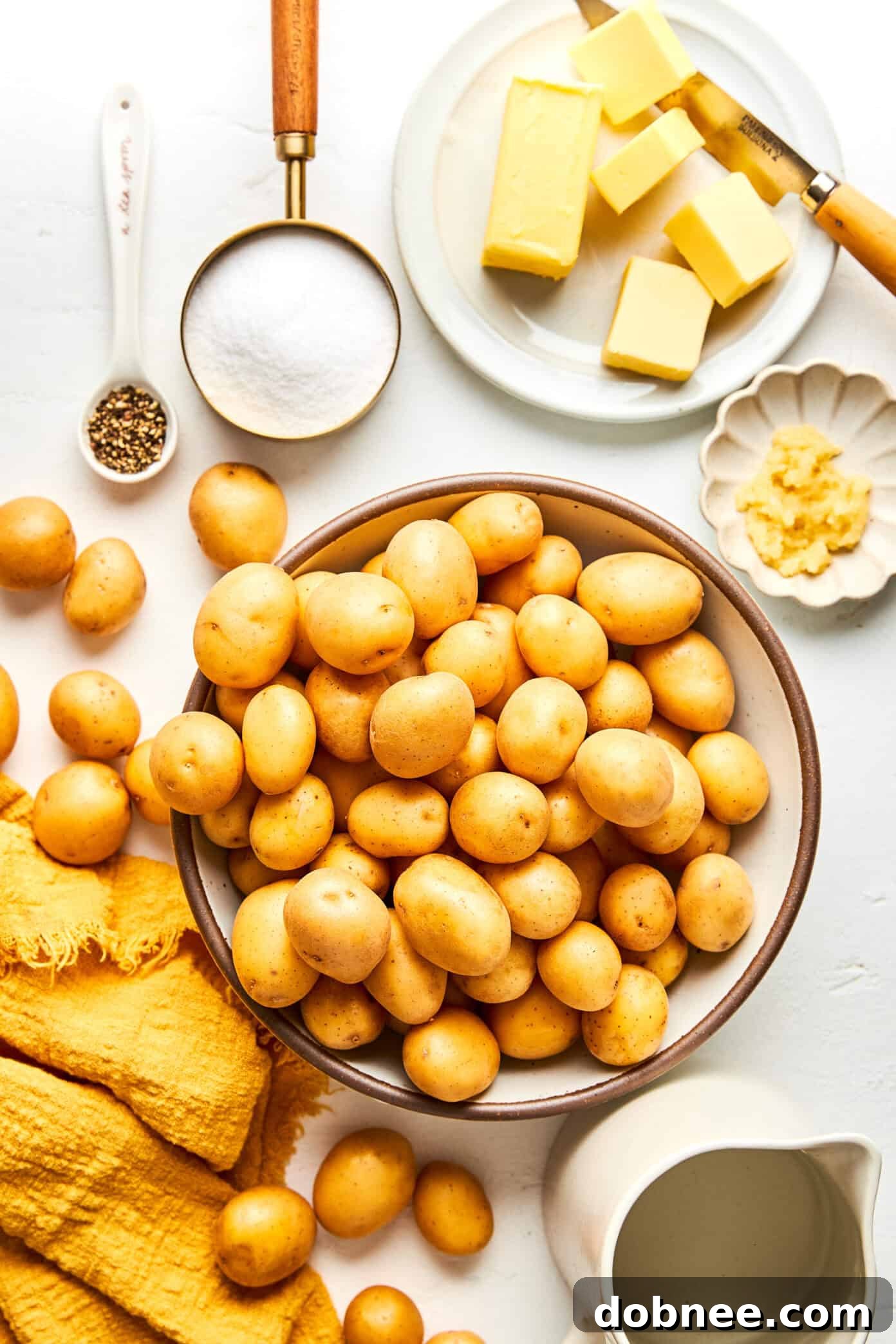 A serving bowl filled with freshly made Syracuse Salt Potatoes, glistening with a white salt coating