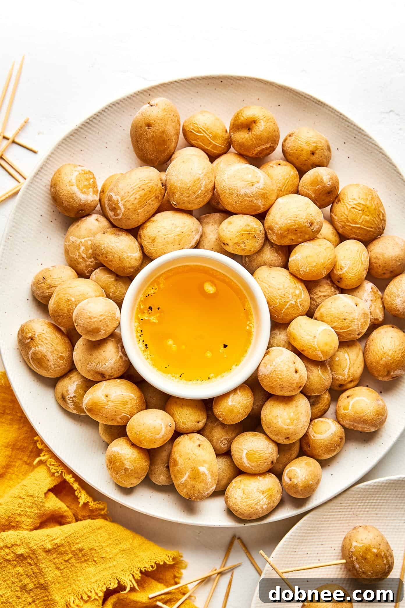 A close-up of Syracuse Salt Potatoes with melted garlic butter drizzled over them