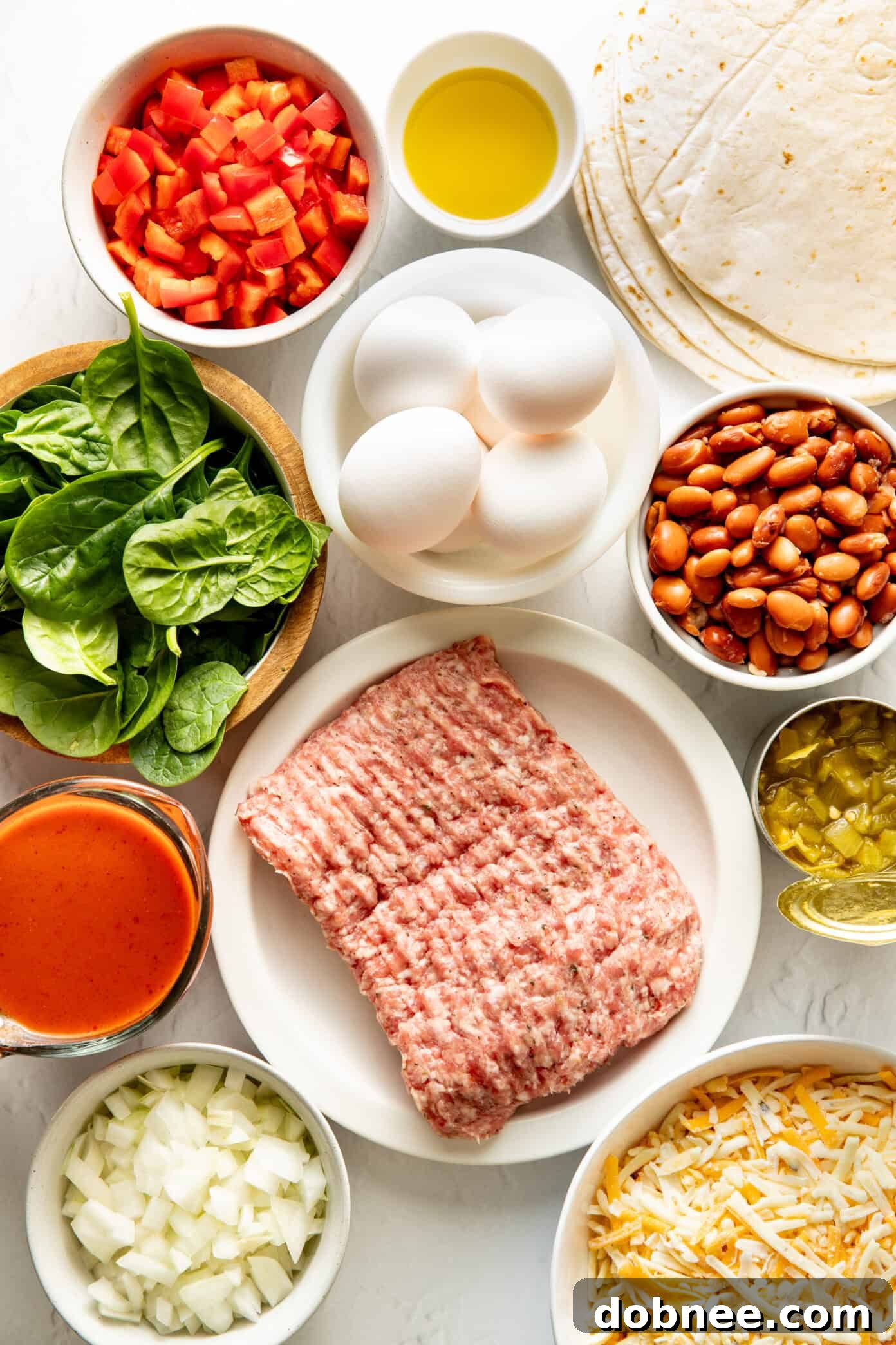 A baking dish filled with pre-baked breakfast enchiladas