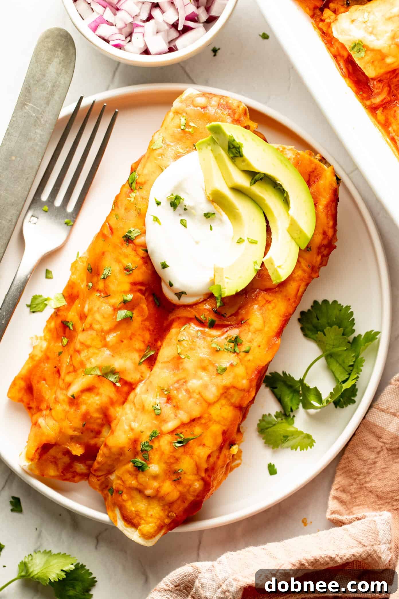 A wider shot of the baked breakfast enchiladas in a pan