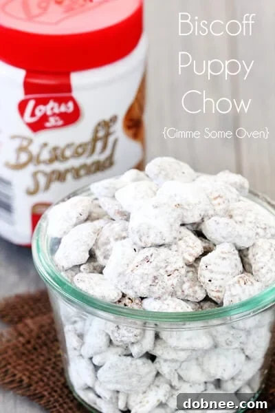 A bowl of Biscoff Puppy Chow with a hand reaching in for a piece, illustrating its irresistible nature.