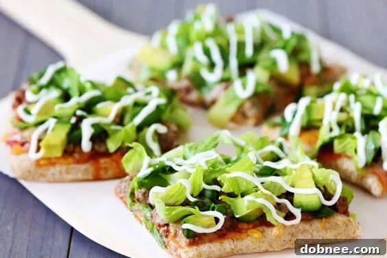 Delicious Taco Pizza loaded with fresh toppings like lettuce, tomatoes, and cheese on a crispy crust. Perfect for a quick and easy family dinner or party appetizer.