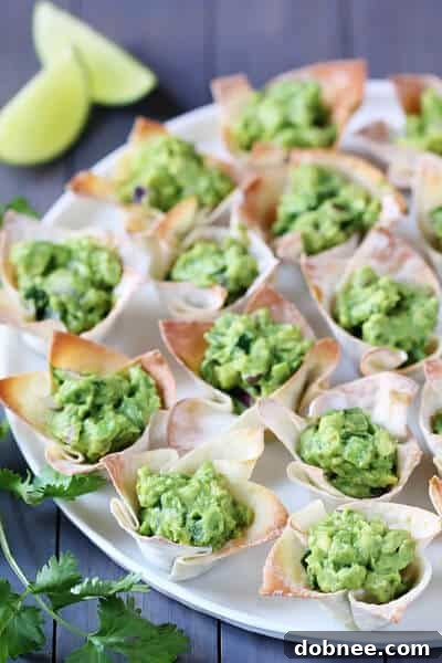 Close-up of a Guacamole Wonton Cup with fresh cilantro garnish.