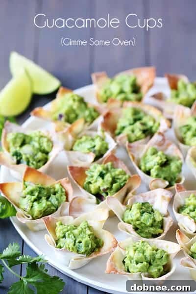 Guacamole Wonton Cups arranged beautifully on a rustic wooden board.