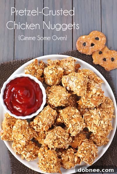 A serving of crispy Pretzel-Crusted Chicken Nuggets presented beautifully on a plate with fresh parsley garnish.