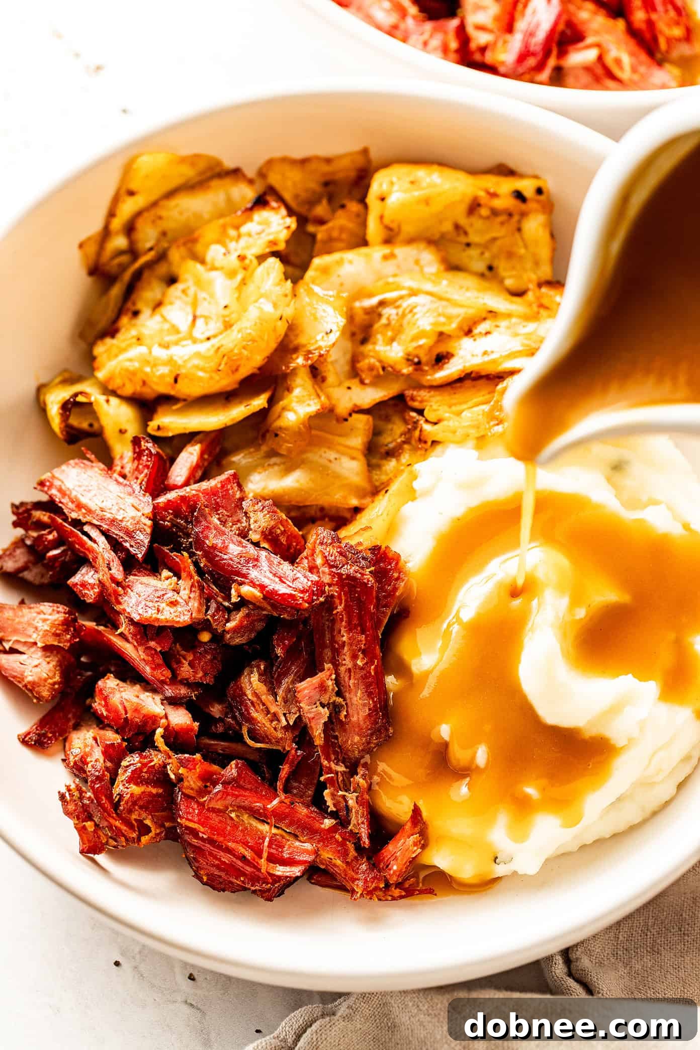 A close-up of crispy shredded corned beef in a cast iron skillet.