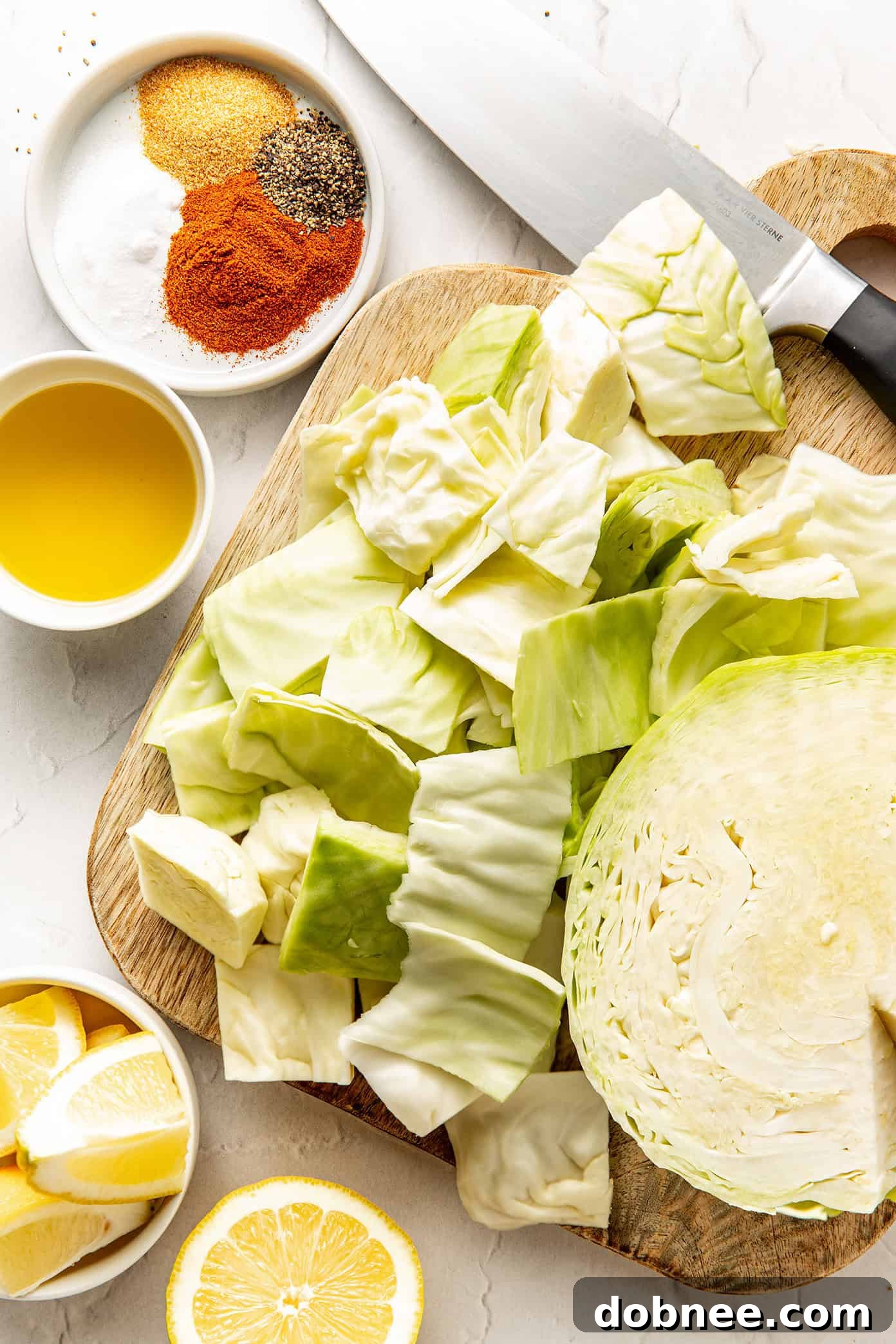 A baking sheet generously filled with evenly seasoned cabbage wedges, perfectly spaced for optimal roasting.
