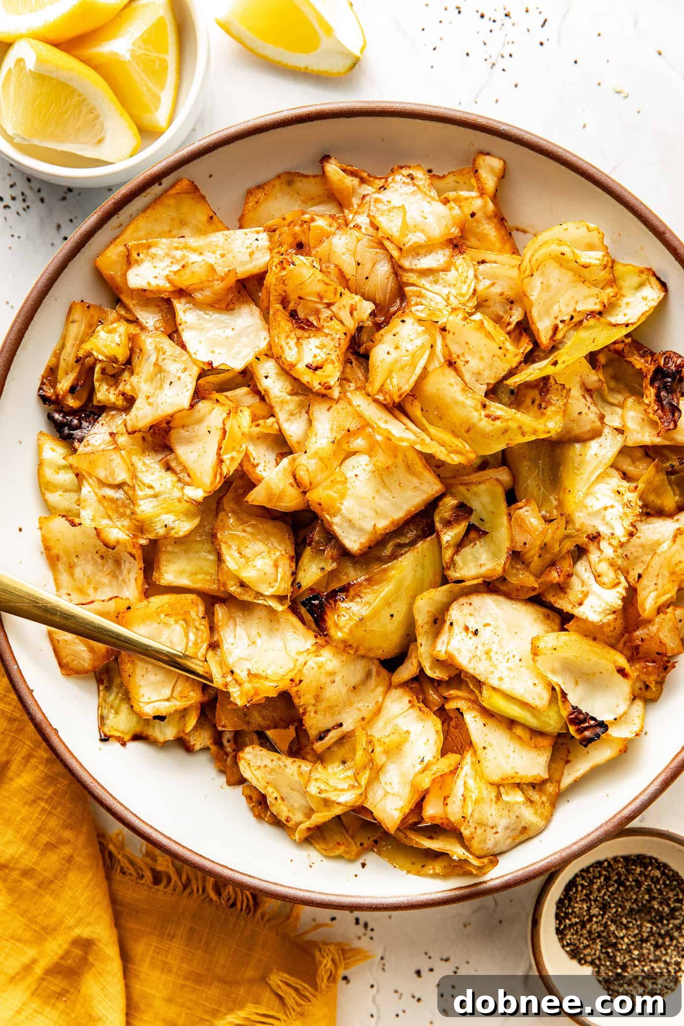 A close-up shot of golden-brown roasted cabbage with a vibrant sprinkle of fresh parsley, emphasizing its appetizing texture.
