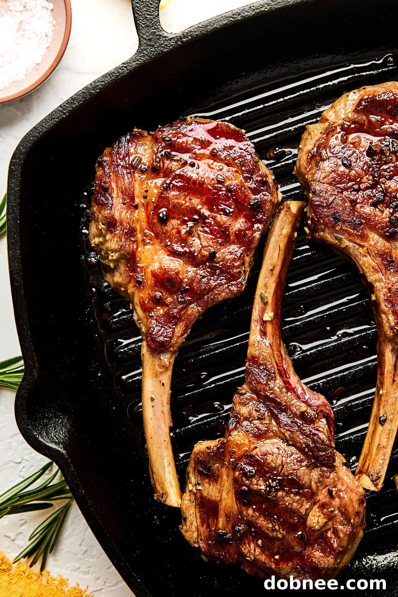 Cooked lamb chops topped with melting lemon butter