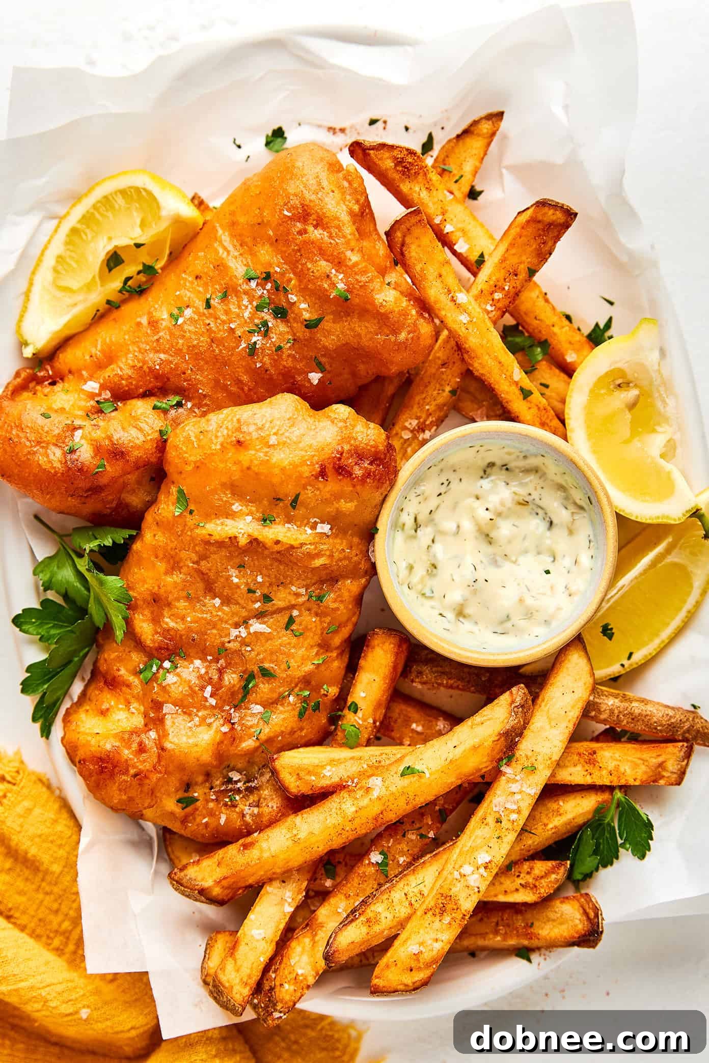 Crispy Old Bay Fish and Chips served with lemon and tartar sauce