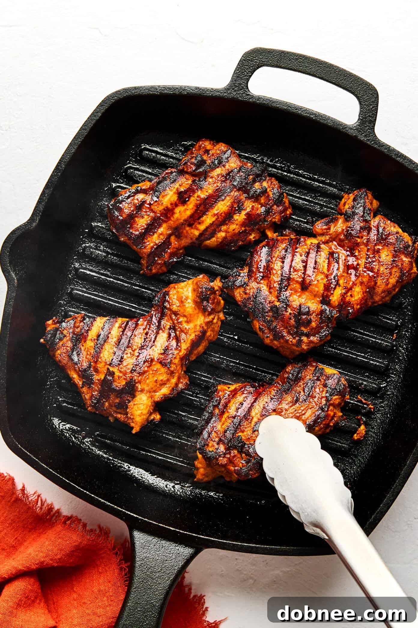 A serving suggestion: Chipotle Chicken served in a soft taco shell with fresh cilantro and lime wedges.