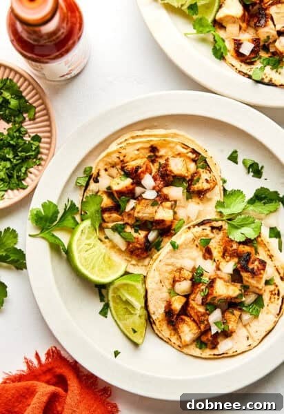 Perfectly cooked Chipotle chicken tacos with fresh toppings.