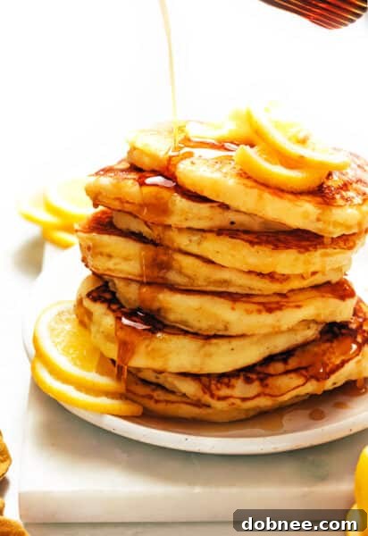 A stack of lemon ricotta pancakes on a plate.