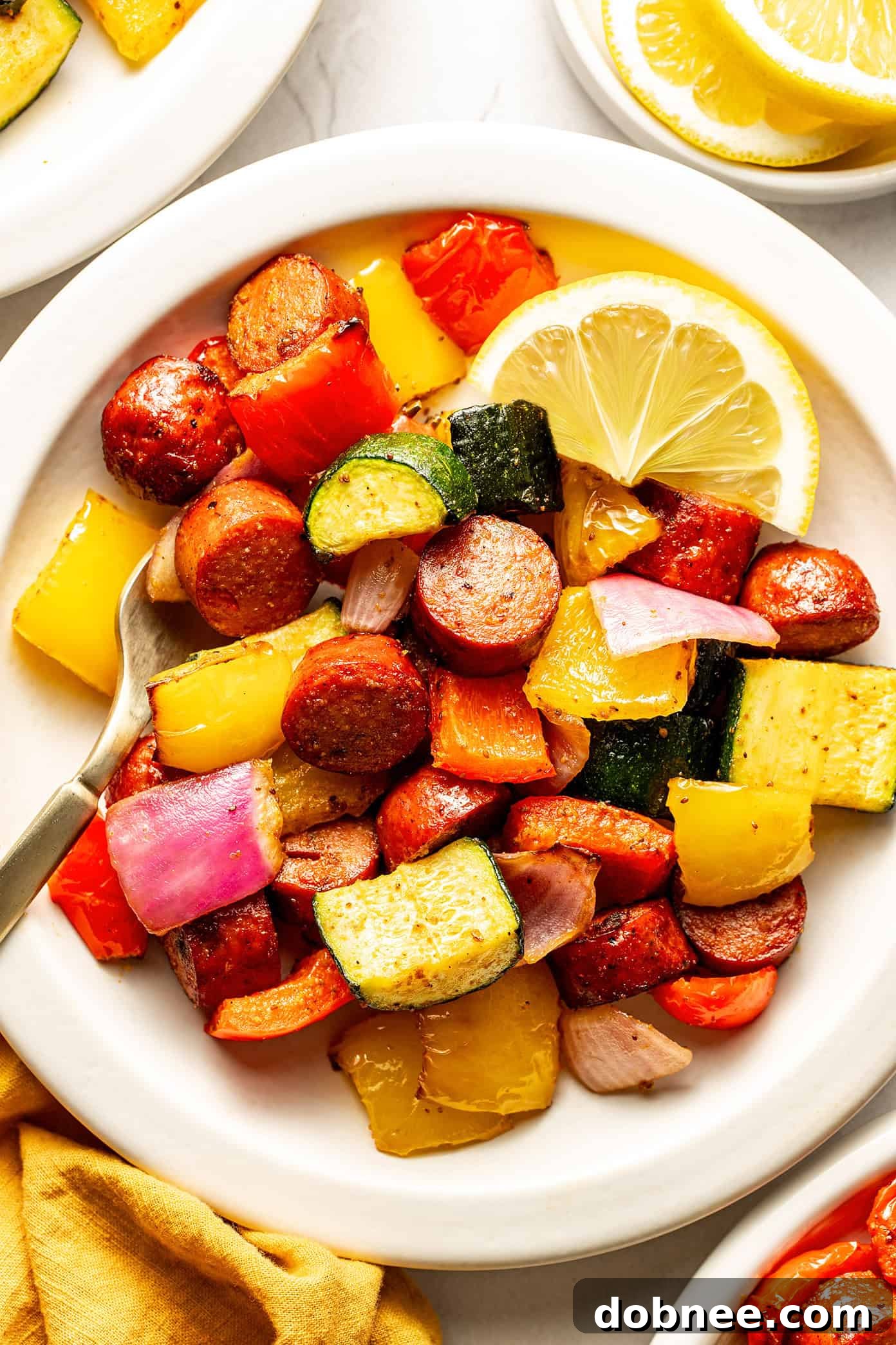 A vibrant bowl of air fryer sausage and vegetables, perfectly cooked and ready to serve.