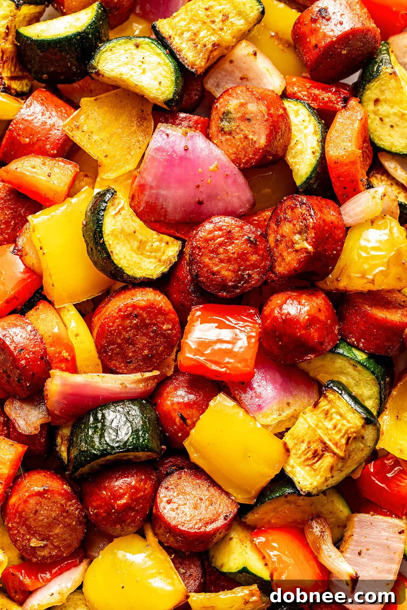 A final hero shot of the air fryer sausage and vegetables in a stylish serving dish.